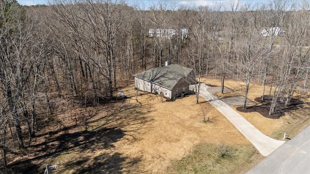 drone / aerial view featuring a wooded view