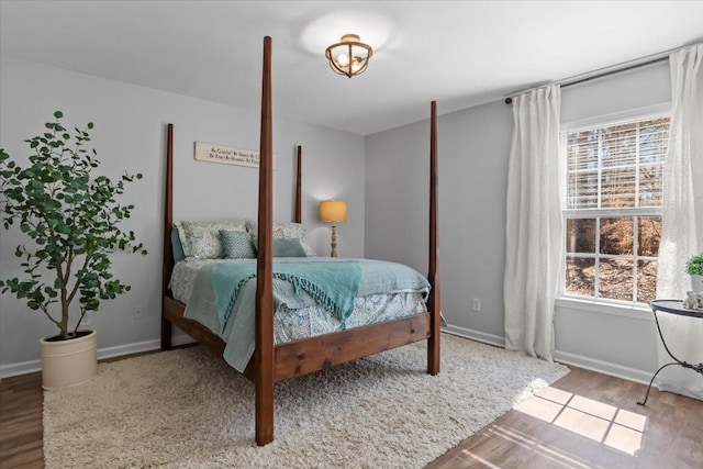 bedroom with wood finished floors and baseboards