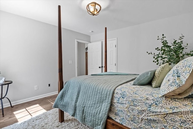 bedroom featuring baseboards and wood finished floors