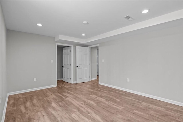 spare room with light wood-style flooring, recessed lighting, baseboards, and visible vents