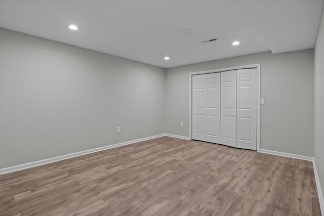 unfurnished bedroom with visible vents, recessed lighting, baseboards, and wood finished floors