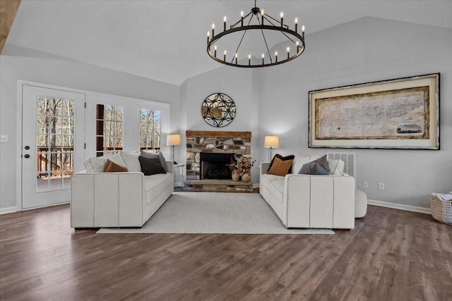 living room with a fireplace, baseboards, lofted ceiling, and wood finished floors