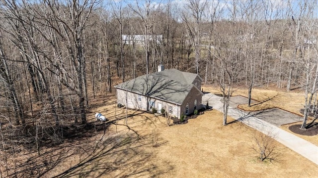 drone / aerial view featuring a wooded view