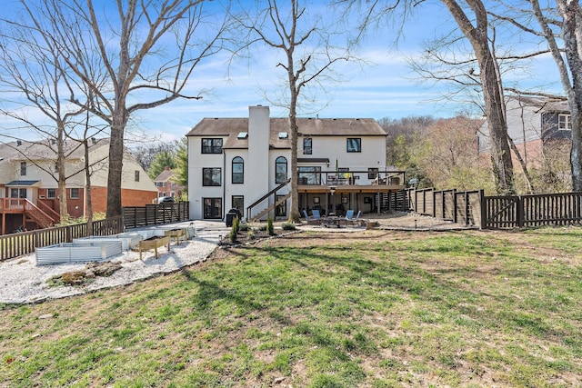 back of house with a patio, stairway, a wooden deck, a yard, and a fenced backyard