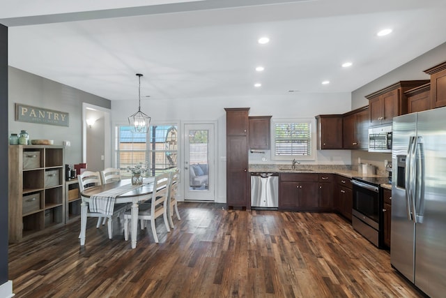 kitchen with dark brown cabinets, light stone counters, recessed lighting, stainless steel appliances, and dark wood-style flooring