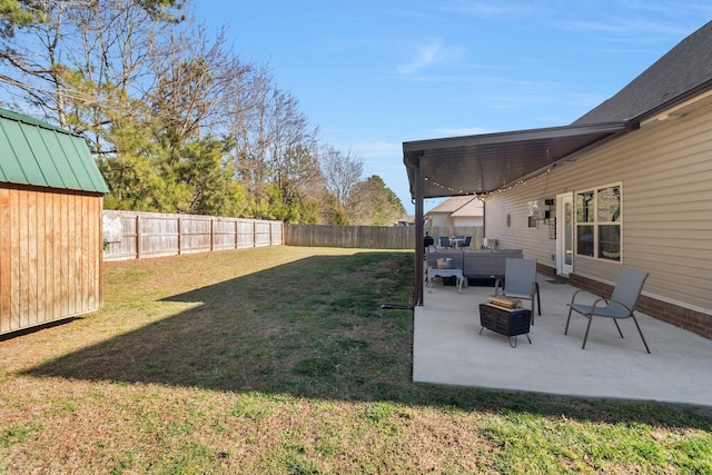 view of yard with an outdoor living space, a shed, a fenced backyard, an outdoor structure, and a patio