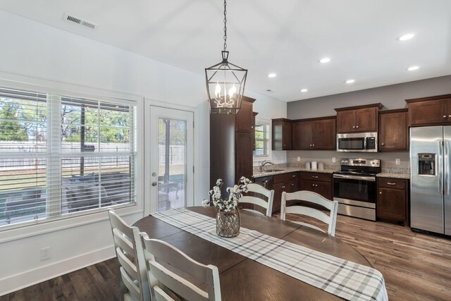 dining space with visible vents, a notable chandelier, recessed lighting, baseboards, and dark wood-style flooring