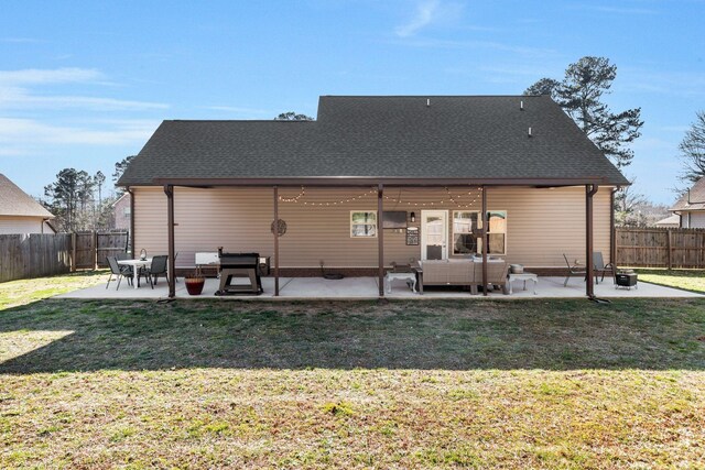 rear view of house with a patio area, a lawn, a fenced backyard, and roof with shingles