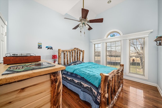 bedroom featuring ceiling fan, baseboards, lofted ceiling, and wood finished floors