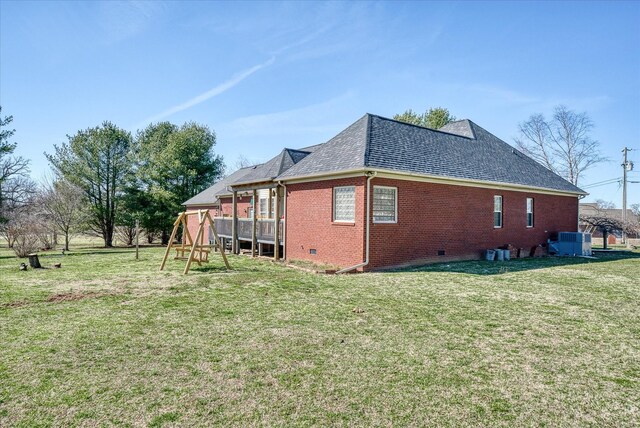 view of property exterior featuring a lawn, a playground, a shingled roof, crawl space, and brick siding