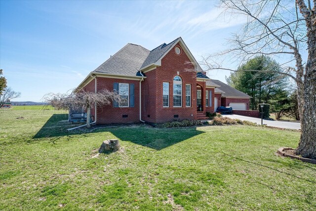 view of front of house with crawl space, brick siding, an attached garage, and a front yard