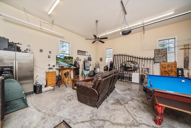 garage featuring a ceiling fan, a garage door opener, and stainless steel refrigerator with ice dispenser