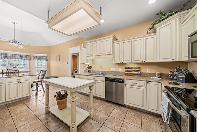 kitchen featuring pendant lighting, a sink, stainless steel appliances, light tile patterned floors, and lofted ceiling