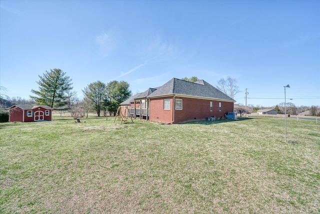 view of yard featuring an outbuilding and a storage unit