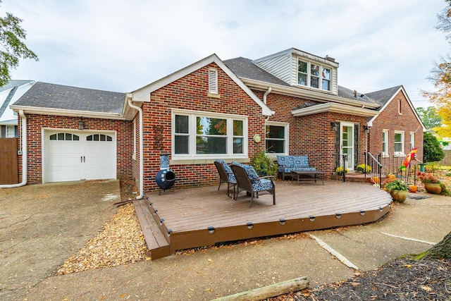 rear view of property with brick siding, an attached garage, a wooden deck, and a shingled roof