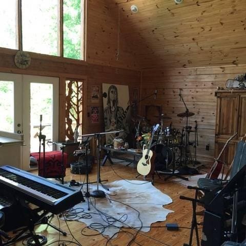 interior space featuring wood walls, wood ceiling, a high ceiling, and wood finished floors