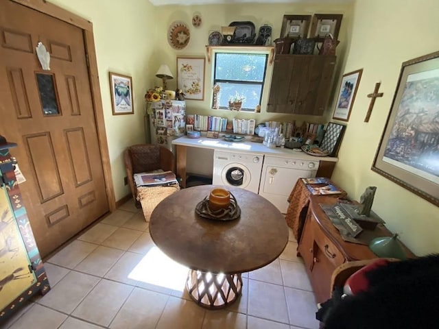 dining area with separate washer and dryer and light tile patterned flooring