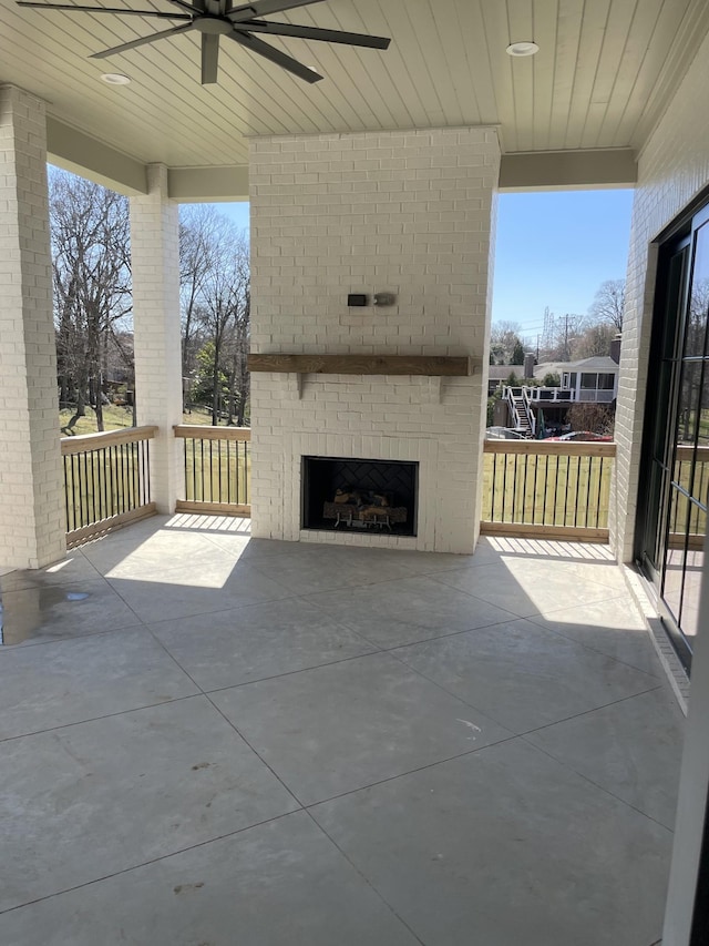 view of patio featuring ceiling fan and an outdoor brick fireplace