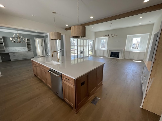 kitchen featuring a fireplace, dark wood-style flooring, a sink, stainless steel dishwasher, and open floor plan