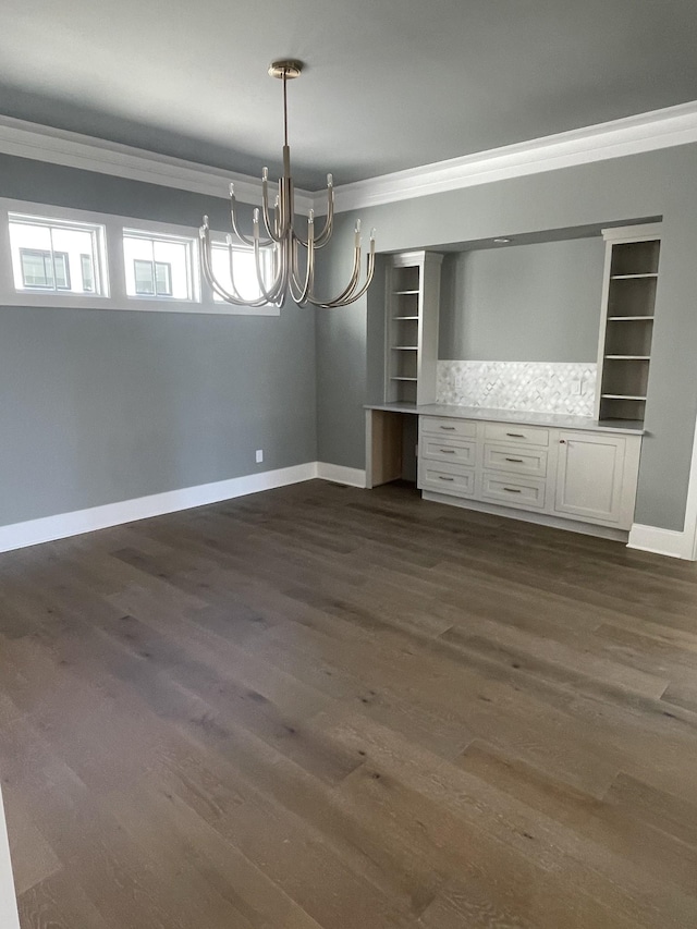 unfurnished dining area with dark wood-style flooring, baseboards, and ornamental molding