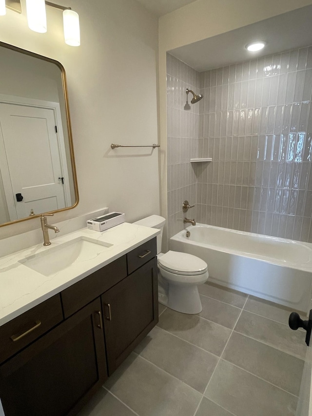 bathroom featuring tile patterned floors, shower / bathtub combination, toilet, and vanity