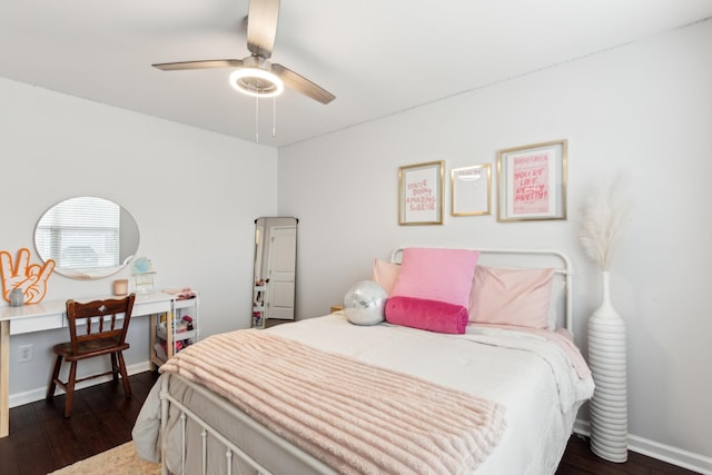 bedroom featuring ceiling fan, baseboards, and dark wood finished floors