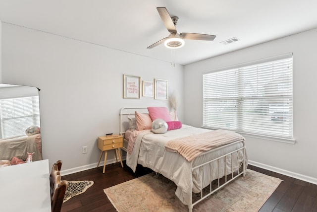 bedroom featuring ceiling fan, visible vents, baseboards, and dark wood-style floors