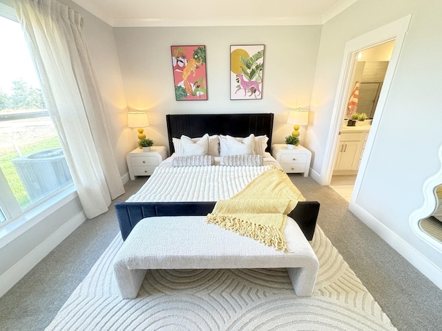 bedroom featuring baseboards, light carpet, connected bathroom, and crown molding