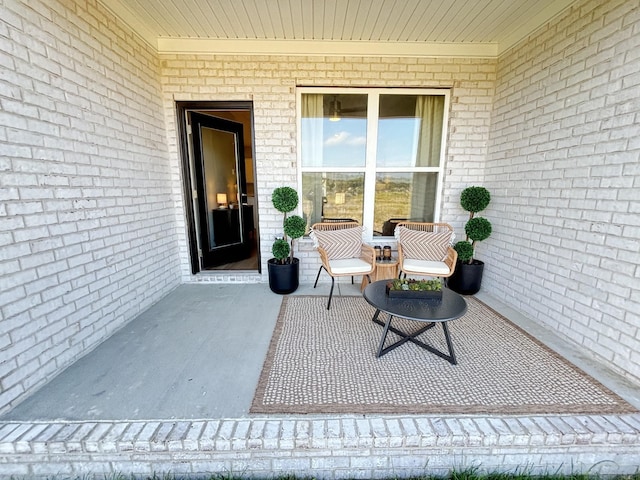 property entrance featuring brick siding