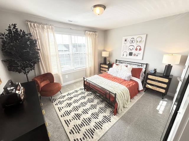 bedroom featuring visible vents, carpet flooring, and baseboards