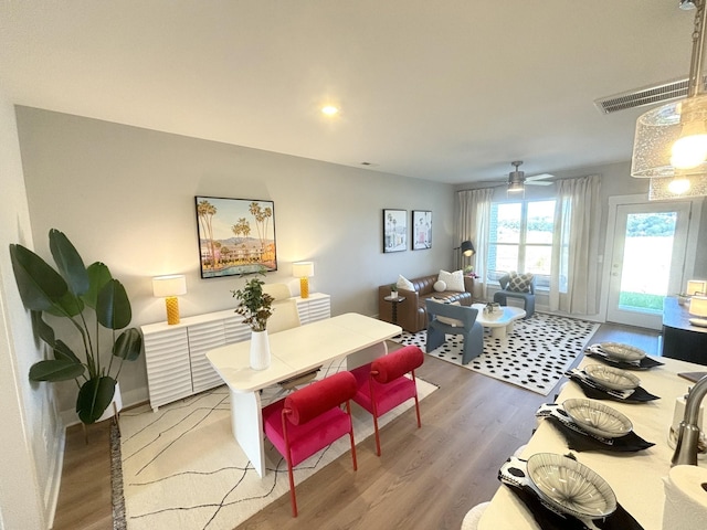 dining area featuring light wood-style flooring, baseboards, visible vents, and ceiling fan