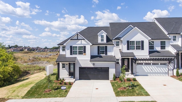 view of front of house featuring concrete driveway, an attached garage, brick siding, and a shingled roof