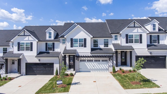 view of front facade featuring a garage, a residential view, brick siding, and driveway