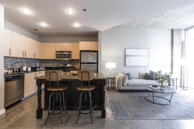 kitchen with visible vents, light brown cabinetry, backsplash, stainless steel appliances, and concrete flooring