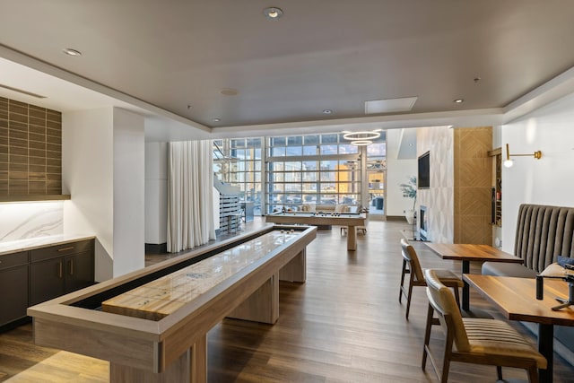 game room with dark wood-type flooring and recessed lighting