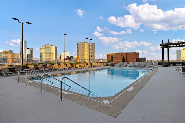 pool featuring a city view and a patio