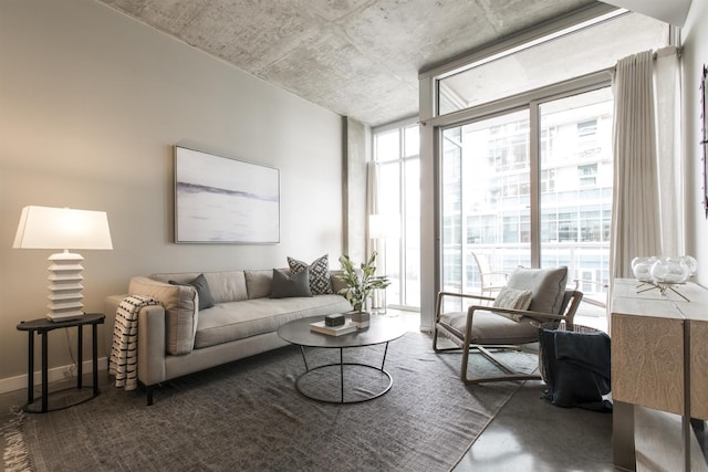 living area with floor to ceiling windows and baseboards