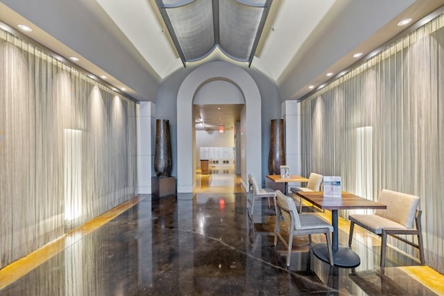 dining room featuring recessed lighting, arched walkways, and lofted ceiling