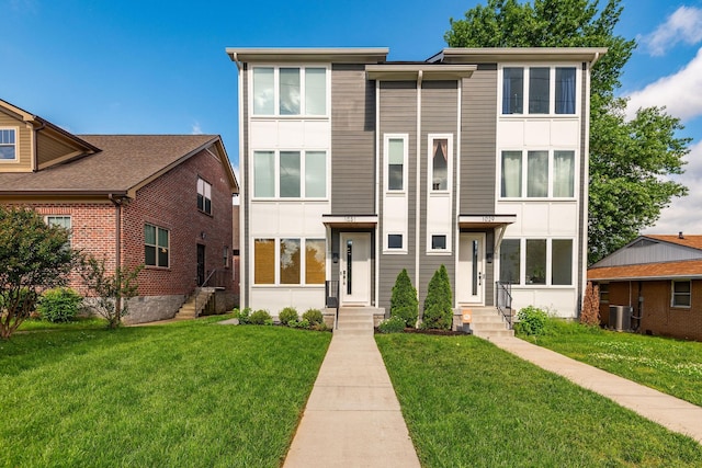 view of front of home featuring a front lawn and central AC