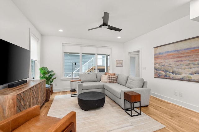 living area with recessed lighting, baseboards, and wood finished floors