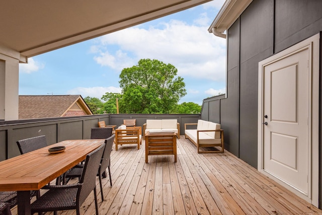 wooden terrace featuring outdoor dining space and outdoor lounge area