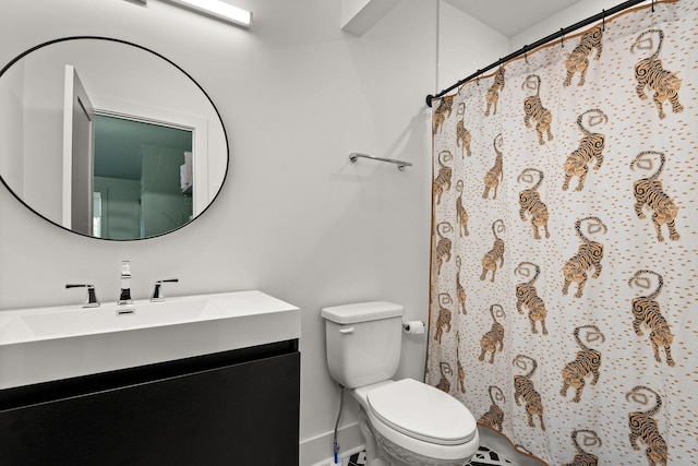 bathroom featuring vanity, a shower with shower curtain, and toilet