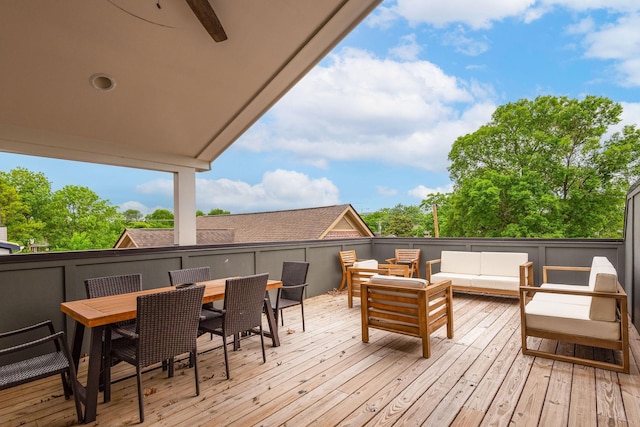 wooden deck with outdoor dining area and an outdoor hangout area