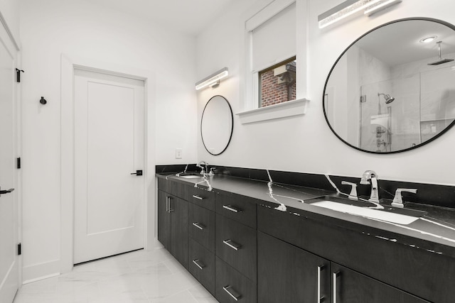 bathroom with a sink, marble finish floor, a stall shower, and double vanity