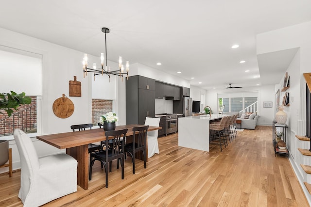 dining area featuring recessed lighting, stairway, and light wood-style flooring