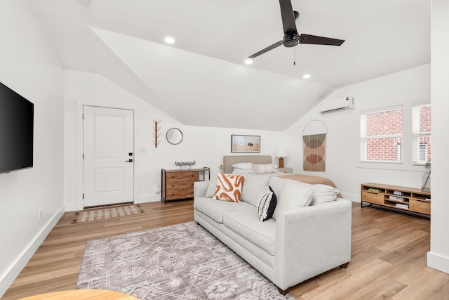 living area with light wood-style flooring, a wall mounted air conditioner, baseboards, and vaulted ceiling