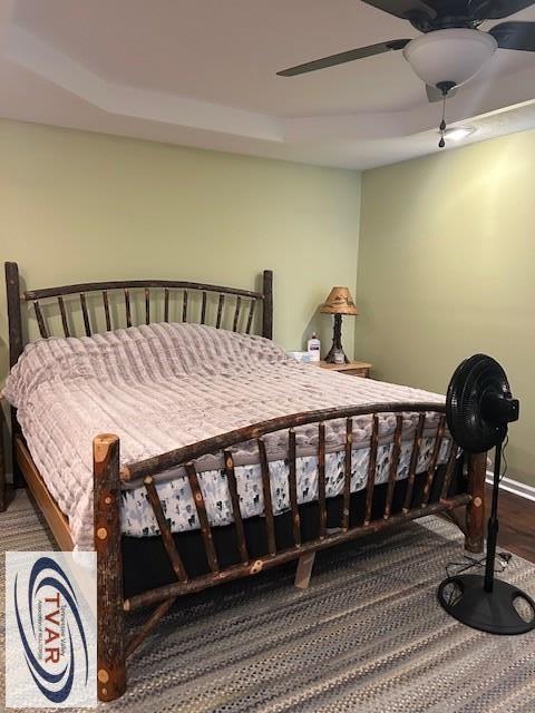 bedroom with baseboards, ceiling fan, and wood finished floors