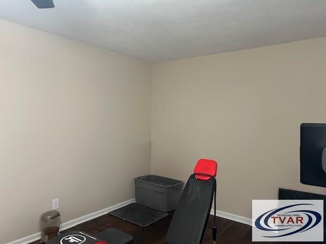 office featuring baseboards and dark wood-style flooring