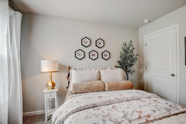 bedroom featuring baseboards and carpet floors