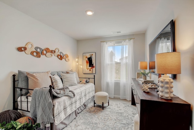 bedroom featuring light colored carpet, visible vents, and baseboards